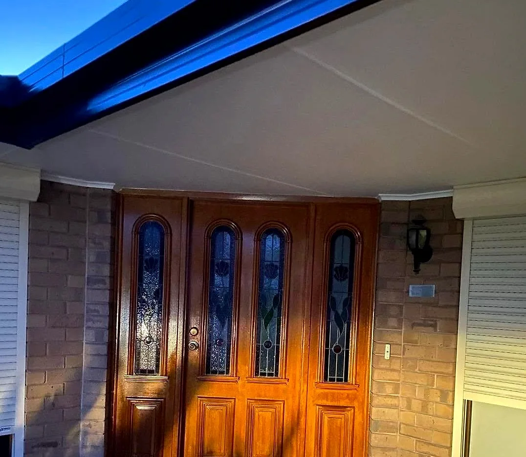 Stained timber front door finished by Hindmarsh Painting
