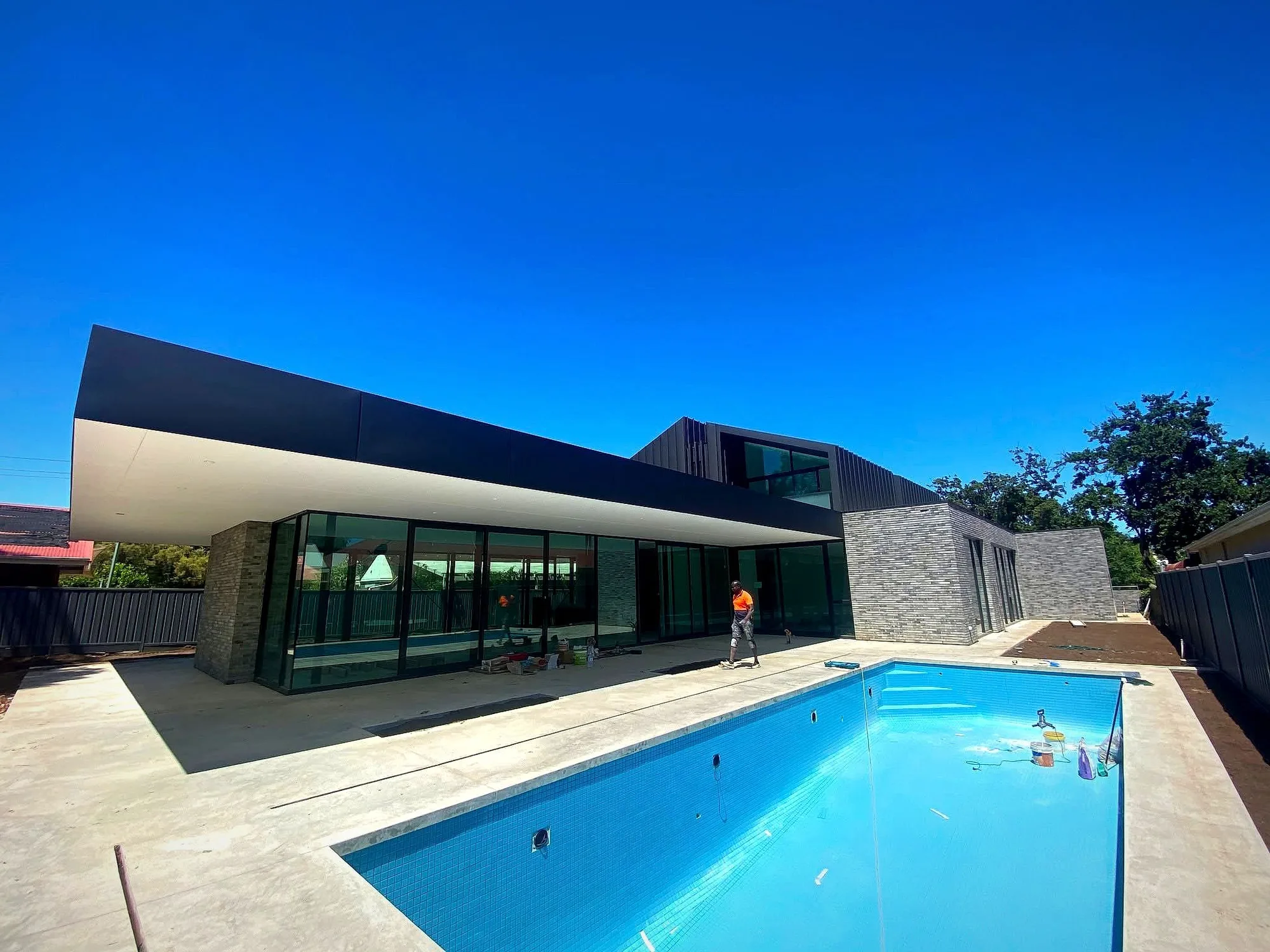 Modern Adelaide home painted by Hindmarsh Painting, charcoal exterior with a pool